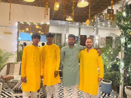 a group of men standing in a room at Hariom Tatsat Retreat in Pushkar