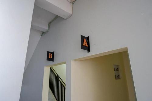 a hallway with a letter and numbers on the wall at Urbanview Hotel Double Tree near RSUD Margono Purwokerto in Purwokerto