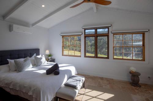 a bedroom with two beds and a ceiling fan at Webbs Creek Farm Retreat in Wisemans Ferry