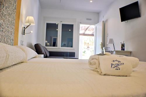 a bedroom with a large bed with a television on it at Hotel Malaga Picasso in Málaga