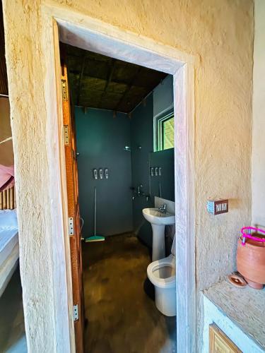 a bathroom with a toilet and a sink at The Cottage Core Village in Borās
