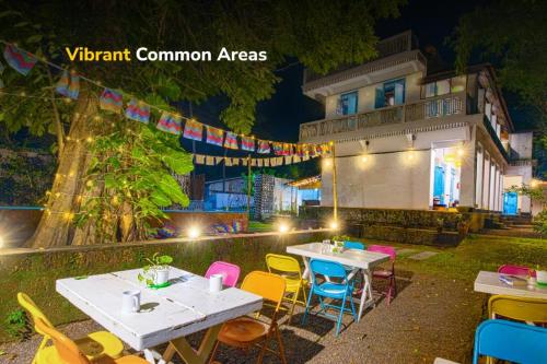 a group of tables and chairs in front of a building at goSTOPS Lite Alleppey in Alleppey