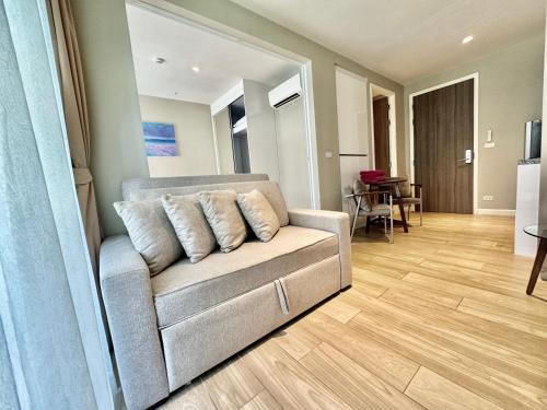 a living room with a couch and a table at Diamond Condo apart near Bangtao beach in Bang Tao Beach