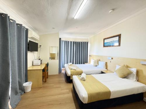 Ένα ή περισσότερα κρεβάτια σε δωμάτιο στο Taree Motor Inn