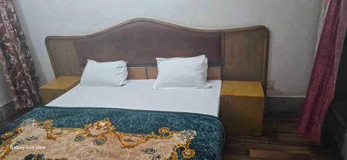 Postel nebo postele na pokoji v ubytování Hotel O Gangay