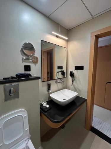 a bathroom with a sink and a mirror at Nirvana Nest - Corporate Stay, Gomti Nagar, Lucknow in Lucknow