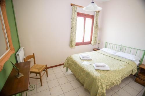a bedroom with a bed with two towels on it at Filoxenia Studios in Galaxidi