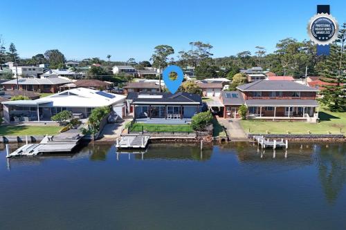an aerial view of a house on the water at Watersedge - Absolute Waterfront in Sussex inlet