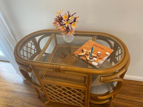 a wooden table with a plate of food and a candle at Allawah at Wamberal in Wamberal