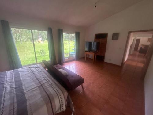 a bedroom with a bed and sliding glass doors at Casa Nueva Holanda in Las Vigas