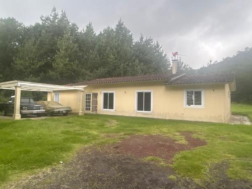 a house with a car parked in front of it at Casa Nueva Holanda in Las Vigas