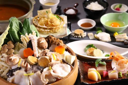a table topped with plates of food and bowls of soup at KAMENOI HOTEL Oarai in Oarai