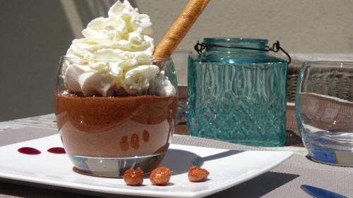 a shake on a plate on a table at Hôtel Saint Jean in Vals-les-Bains