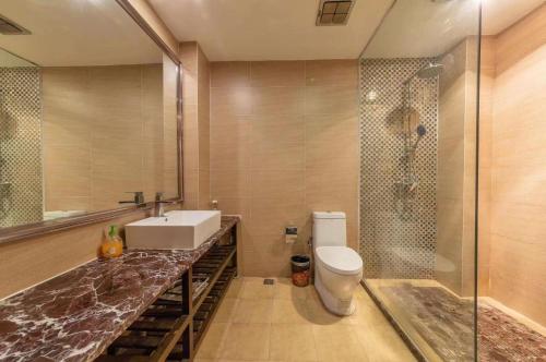 a bathroom with a sink and a toilet and a shower at Mengtianhu Inn in Lijiang