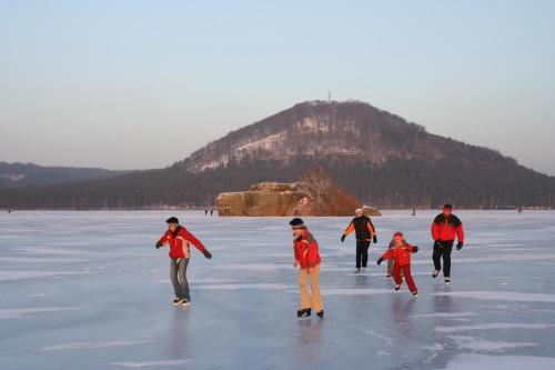 a group of people walking on the ice at Hotel Port Doksy in Staré Splavy