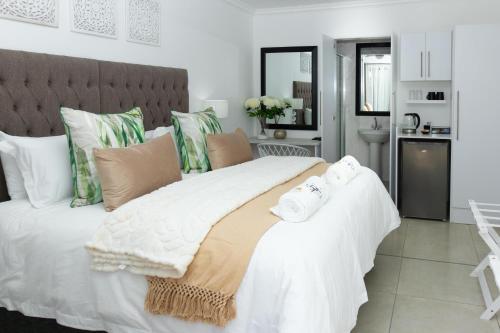 a bedroom with a large white bed with towels on it at Relmies Place in Modimolle