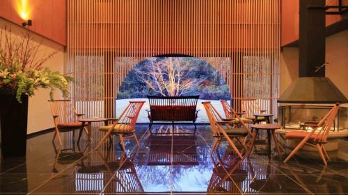 a room with chairs and a table and a tree at Hakone Fuga - Adult Only in Hakone