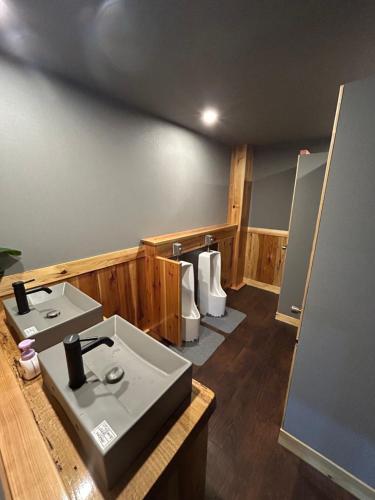a bathroom with a sink and two toilets at Butter Hotel in Otari
