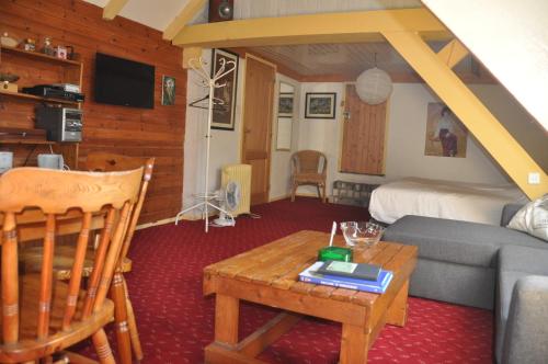 a living room with a bed and a couch and a table at De Hoge Peel in Heythuysen