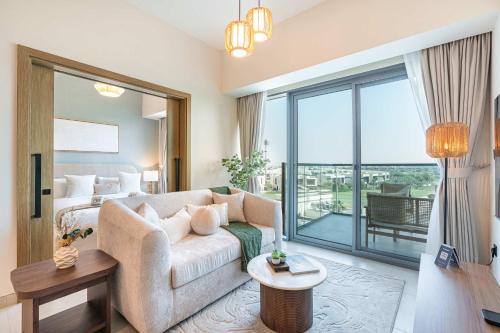 un salon avec un canapé et une grande fenêtre dans l'établissement PVH - Modern 1BR with Golf Course View - Golf Gate, à Dubai Marina