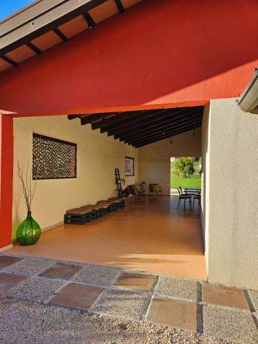 a large room with a red ceiling and a living room at Dolcevita guest house in Torreano