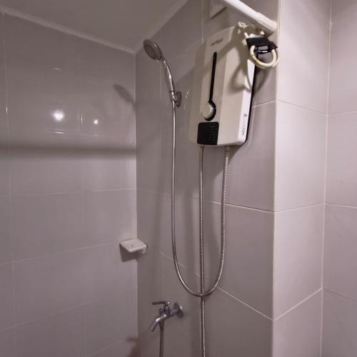 a shower in a bathroom with a phone on the wall at Rae Condo at Marina Spatial Seaview and Mountain View in Aganan