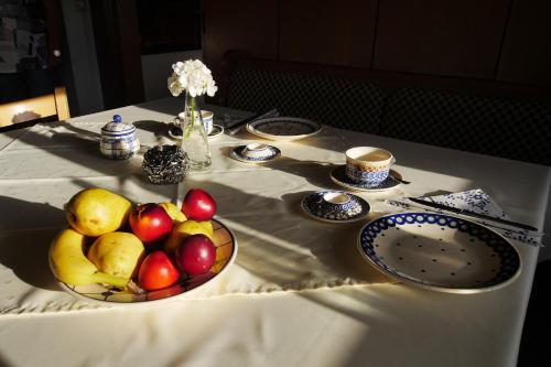 a table with a bowl of fruit on a table at Pension Patz in Schladming
