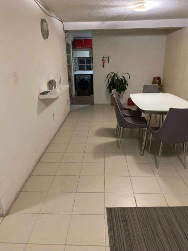a kitchen and dining room with a table and chairs at Departamento E-5 metro Copilco UNAM Coyoacan in Mexico City