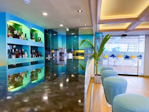 a room with a bar with blue walls and stools at RITRELLA FLOATING HOTEL&YACHT - FREE beach access daily - Full board meal plan in Male City