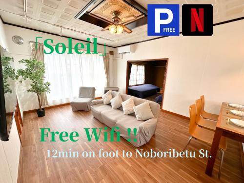 a living room with a couch and a table at Soleil ソレイユ 一棟貸切 in Noboribetsu