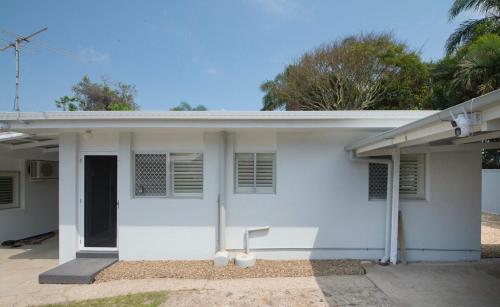 a white house with a door and a window at Haven at Redcliffe - your stay on the Peninsula in Redcliffe