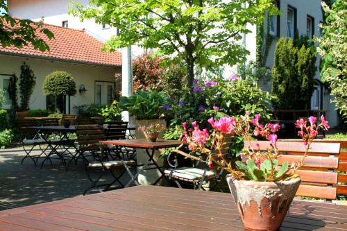a table with a bunch of flowers on a patio at Bärenkrug in Molfsee
