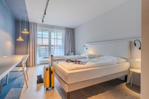 Postel nebo postele na pokoji v ubytování ibis Styles Graz Messe