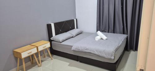 a small bed with two pillows on it in a room at Wonder Villa in Bandar Penawar