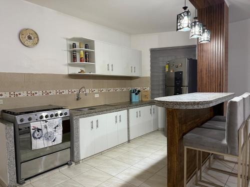 a kitchen with white cabinets and a counter top at LibiMar in Manta