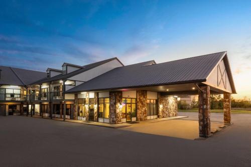 a rendering of a building with a black roof at Days Inn by Wyndham Branson Ozarks in Branson
