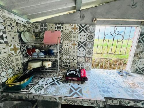 a room with tiles on the wall and a toy car on the floor at Giay's Local House in Sapa