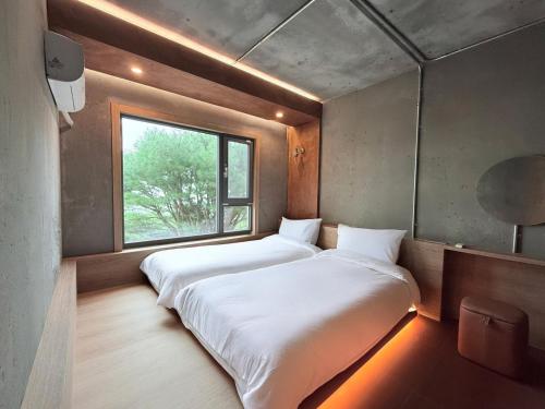 Postel nebo postele na pokoji v ubytování Gyeongju Mauna Ocean Resort