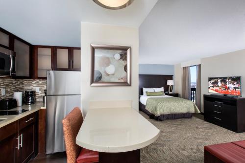 a hotel room with a kitchen and a bedroom at Staybridge Suites Atlanta - Midtown by IHG in Atlanta