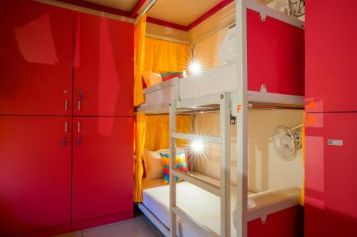 a bunk bed room with red and yellow walls at goSTOPS Coorg in Madikeri