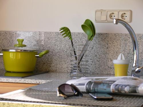 a kitchen counter with a sink with glasses and a faucet at Sky Touristic Attic in Valencia