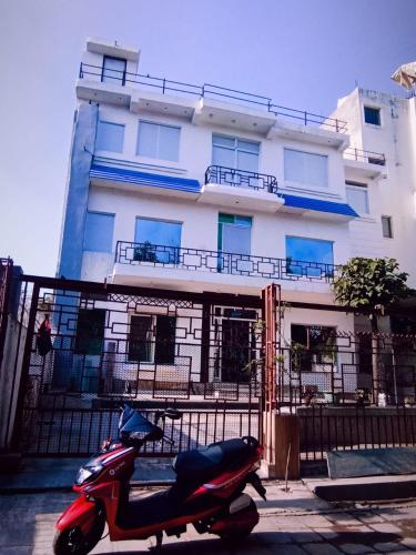 a scooter parked in front of a building at Soooper Hotel 2 in Jāmb