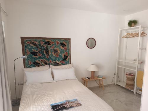 a bedroom with a bed with a tapestry above it at Chiarù in Naples