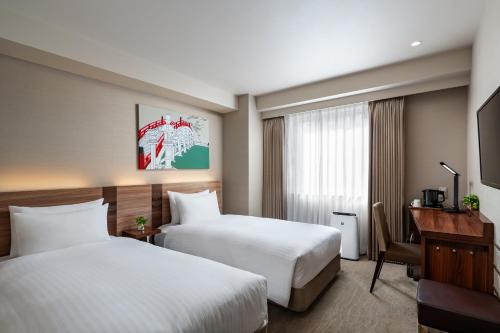 Postel nebo postele na pokoji v ubytování Noku Osaka