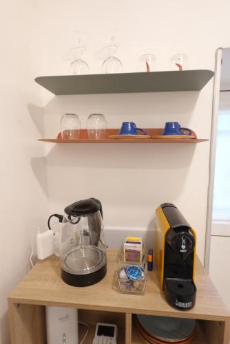 a coffee maker and a toaster on a shelf at Chiarù in Naples