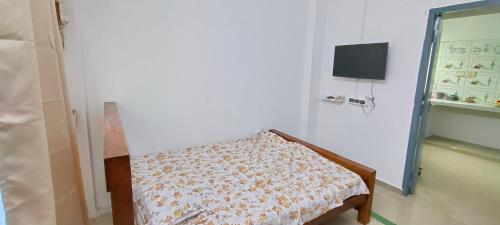 Ένα ή περισσότερα κρεβάτια σε δωμάτιο στο Kumar's Divinestay