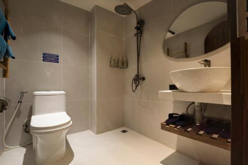 a bathroom with a toilet and a sink at Lune Boutique Apartment Da Nang in Da Nang
