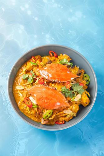 a bowl of food on top of a blue table at Kempinski Hotel Hangzhou in Hangzhou