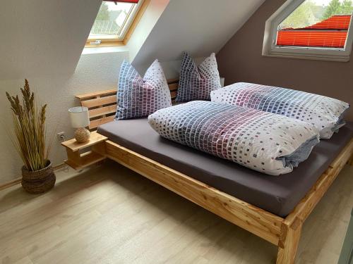 a bed with pillows on it in a room at Ferienwohnung Schreiter in Arnsfeld