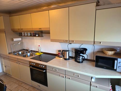 a kitchen with a sink and a counter top at House of Haiger Ferienwohnung mit Charme in Haiger